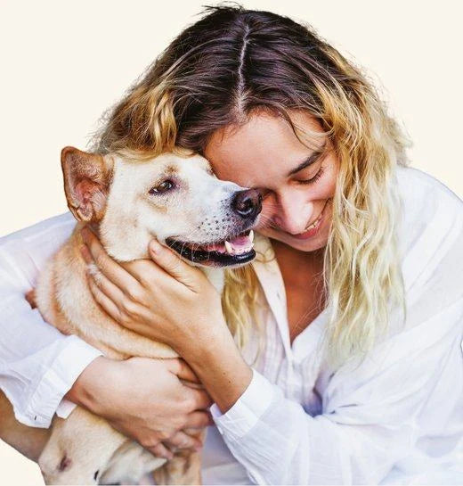 A pet parent cuddling her dog